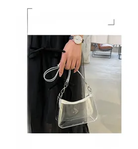 Detail view of the transparent PVC underarm bag with white zipper and clear shoulder strap