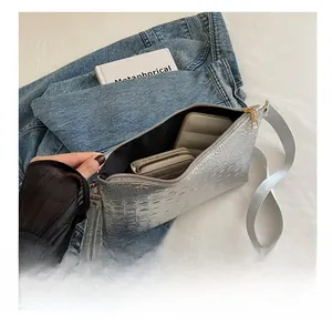 Silver crocodile texture bag showing interior capacity for long wallet and phone