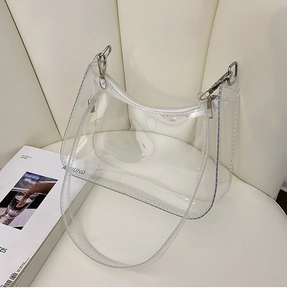 Macro shot of clear PVC material with white zipper and silver metal hook on the handbag
