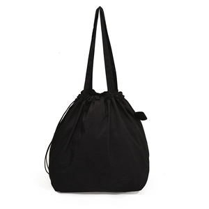 Minimalist black nylon bucket bag with drawstring closure and dual shoulder straps