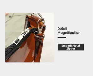 Detail of smooth black metal zipper and silver hardware on amber transparent PVC bag