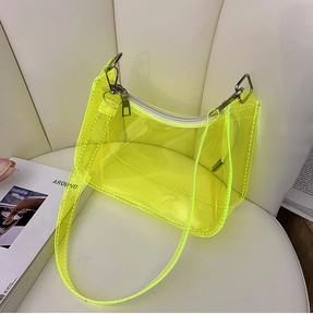 Close-up of fluorescent yellow transparent PVC hobo bag with silver metal zipper detail