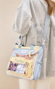 Detail of a pastel nylon crossbody bag with transparent window and adjustable shoulder strap