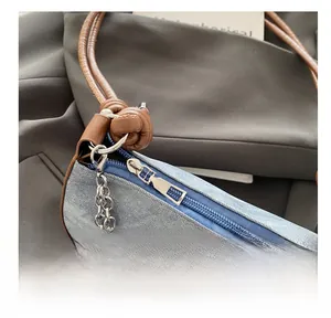 Detailed shot of denim fabric with silver bow accent and elegant pearl chain ornament