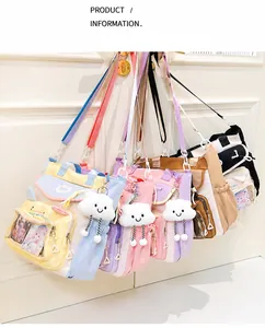 Detail of colorful nylon messenger bags with transparent windows and plush cloud charms