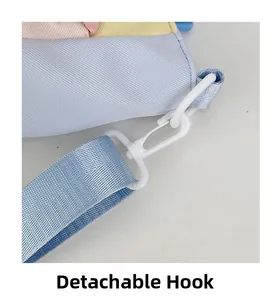 Detail of the detachable plastic hook and colorful nylon shoulder strap of the school bag