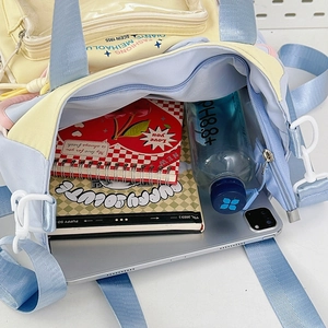 Detail of multi-color nylon tote bag showing spacious interior with tablet and books