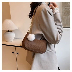 Brown corduroy shoulder bag with white pompom charm and gold chain strap for women