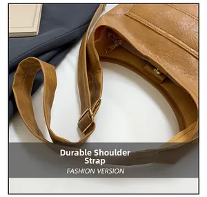 Close-up of durable shoulder strap and vintage textured leather on a brown crossbody bag