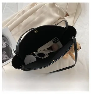 Top view of spacious black tote bag interior with magnetic closure and bear charm