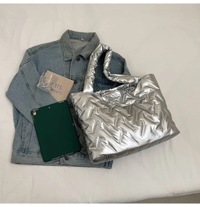 Top view of large silver tote bag with quilted texture and metallic finish for daily use