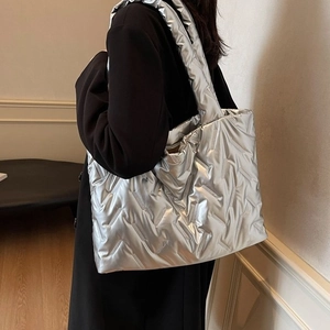Large capacity silver puffer tote bag with quilted texture and padded shoulder strap