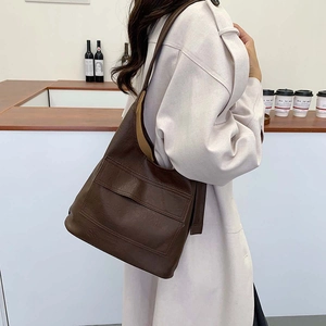 Minimalist large brown faux leather tote bag for women showing spacious daily commute design