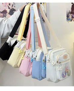 Detailed view of colorful mini crossbody bags with clear pockets and cartoon badges