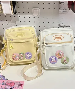 Clear window ita bags in pale yellow and off-white with cute badges and straps