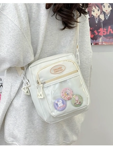Detailed side view of white ita bag with transparent pocket and cute rabbit pins