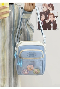 Detail view of the clear PVC front pocket showing three cute bunny theme badges