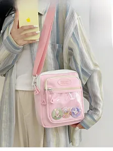 Detailed view of pink and white ita bag with large transparent PVC window and badges