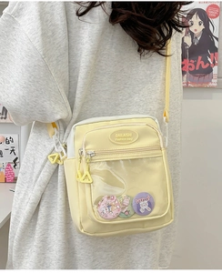Side view of yellow fashion crossbody bag with clear PVC pocket and cute rabbit badges