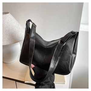 Detail der feinen Lederstruktur und glatten Nähte der schwarzen Hobo-Tasche