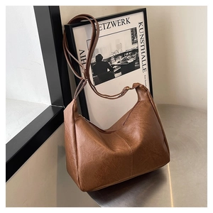 Detailansicht der braunen PU-Ledertasche mit verstellbarem Riemen und strukturierter Oberfläche