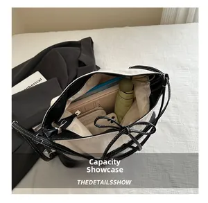 Detail view of canvas tote bag interior showing capacity for laptop, umbrella, and essentials