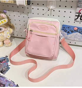 Detail showing pink canvas ita bag with transparent PVC pocket and adjustable strap
