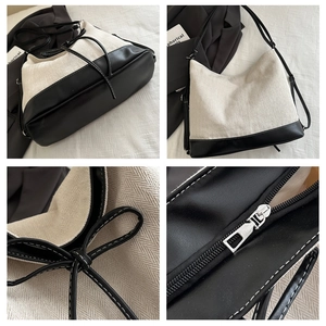 Close-up of contrast stitching and bow detail on casual canvas tote with leather trim