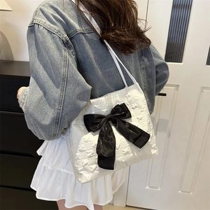 Women black and white contrast tote bag with large bow and quilted texture shoulder straps