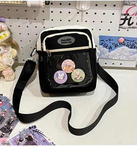 Detail of clear display pocket on black and white canvas bag with rabbit badges
