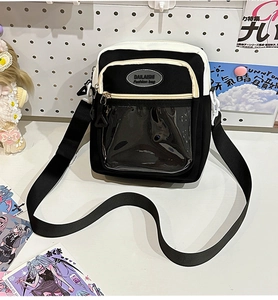 Detail of a black and white Ita-bag with transparent PVC window for badges and accessories