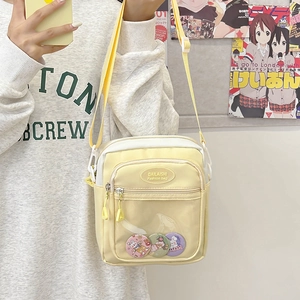 Clear yellow Ita bag crossbody with transparent front pocket for anime badges display