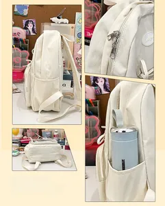 Detailed view of the side water bottle pocket and smooth metal zipper on white canvas backpack