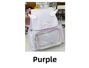 Detail of purple polka dot schoolbag featuring decorative 3D wings and a pink bow decoration