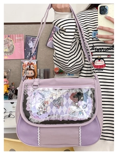 Close-up of light purple ita-bag with clear PVC window, lace trims, and decorative bows