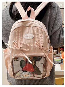 Detailed view of pink school backpack with transparent display window and bow details
