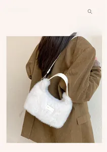 Close-up of fluffy white faux fur shoulder bag with leather handle and metal strap buckle