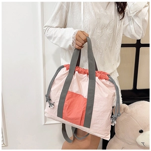 Pink and coral drawstring tote bag made of lightweight nylon for commute or travel