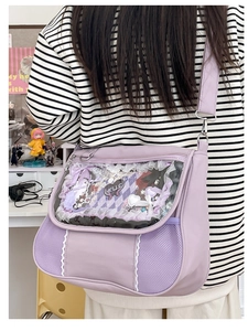 Detail view of light purple ita bag with clear window and lace decoration on straps
