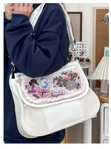 White ita bag with transparent window and lace detailing worn as a crossbody bag