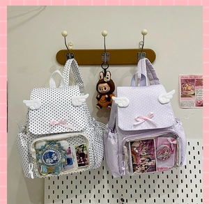 Close-up of polka dot ita bags with transparent display windows and cute wing decor