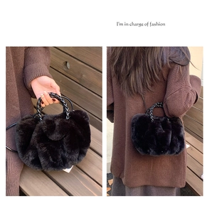 Detail of black faux fur plush handbag featuring unique twisted braided handle and strap