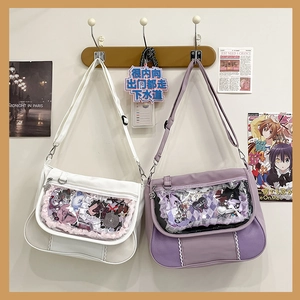 Detail of white and purple Ita bags featuring clear display windows and lace trim