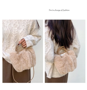Detail view of beige plush crossbody bag featuring woven handles and soft faux fur texture