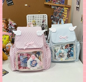 Close-up of the transparent PVC display window and plush wing details on the Ita bag
