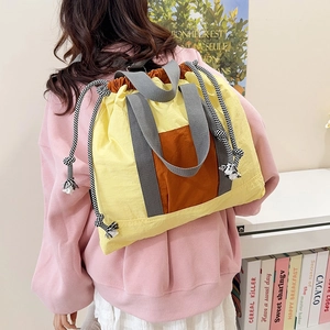 Vibrant yellow and orange drawstring backpack with large capacity for travel and commute
