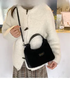 Detail of a fluffy faux fur crossbody bag featuring a love every day label and leather handle