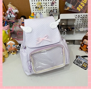 Detail view of purple polka dot school bag with clear window and plush wings decor