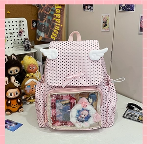 Pink polka dot backpack with transparent window and decorative white angel wings