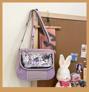 Detail view of a lavender canvas ita bag featuring a large clear window with lace trim